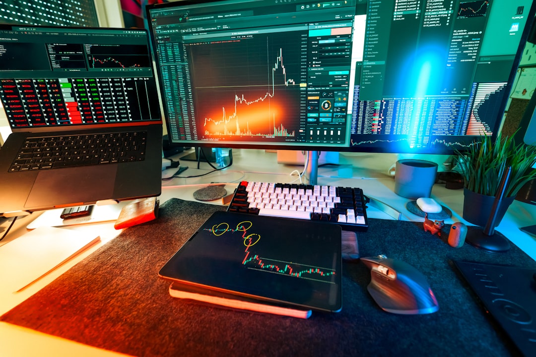 A professional trader's desk showing multiple monitors with technical analysis charts and real-time performance metrics. A professional trader's desk showing multiple monitors with technical analysis charts and real-time performance metrics.
