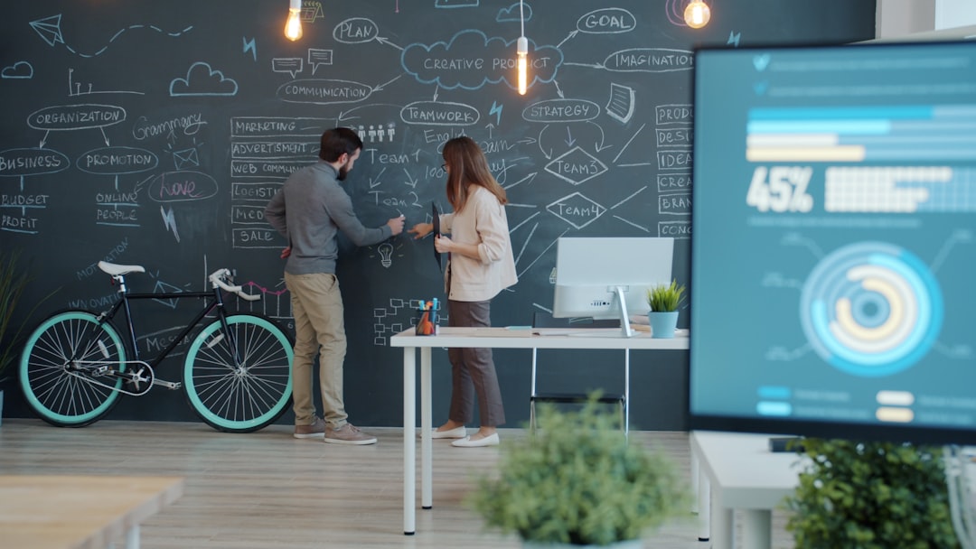 An upward-trending digital analytics graph displayed prominently in a futuristic, clean office environment workspace An upward-trending digital analytics graph displayed prominently in a futuristic, clean office environment workspace