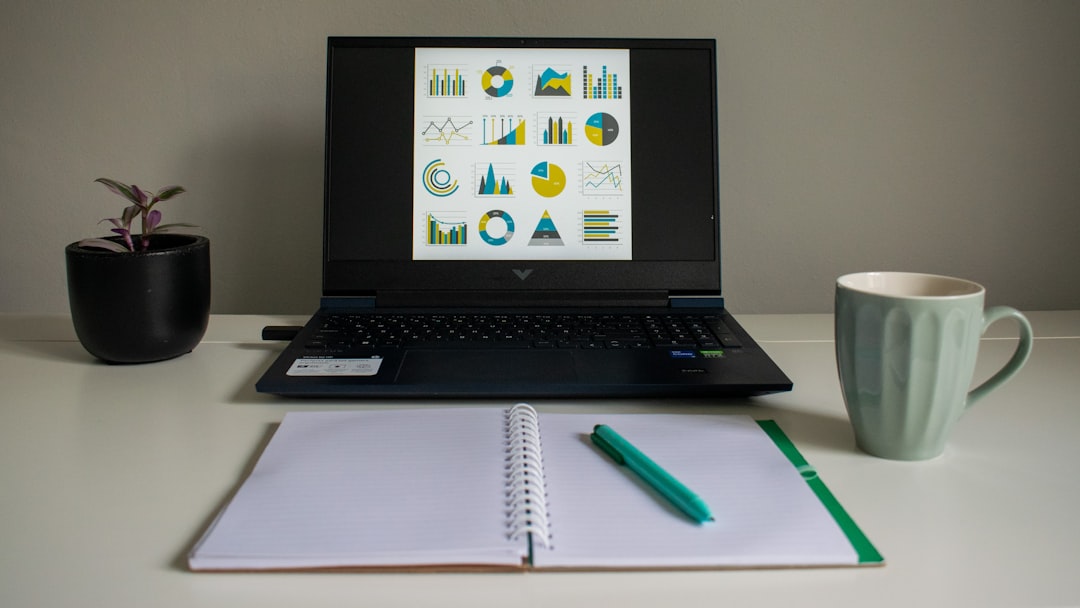 A clean, minimalist office desk with a laptop showing a detailed financial asset allocation chart next to a notebook. A clean, minimalist office desk with a laptop showing a detailed financial asset allocation chart next to a notebook.