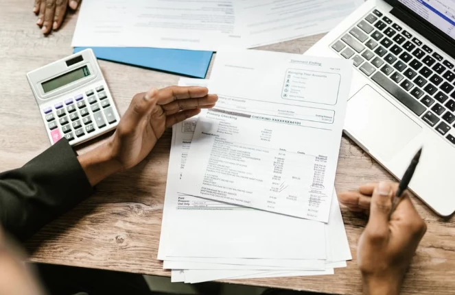 A professional tax advisor reviewing complex digital spreadsheets and cryptocurrency account statements on a laptop screen. A professional tax advisor reviewing complex digital spreadsheets and cryptocurrency account statements on a laptop screen.