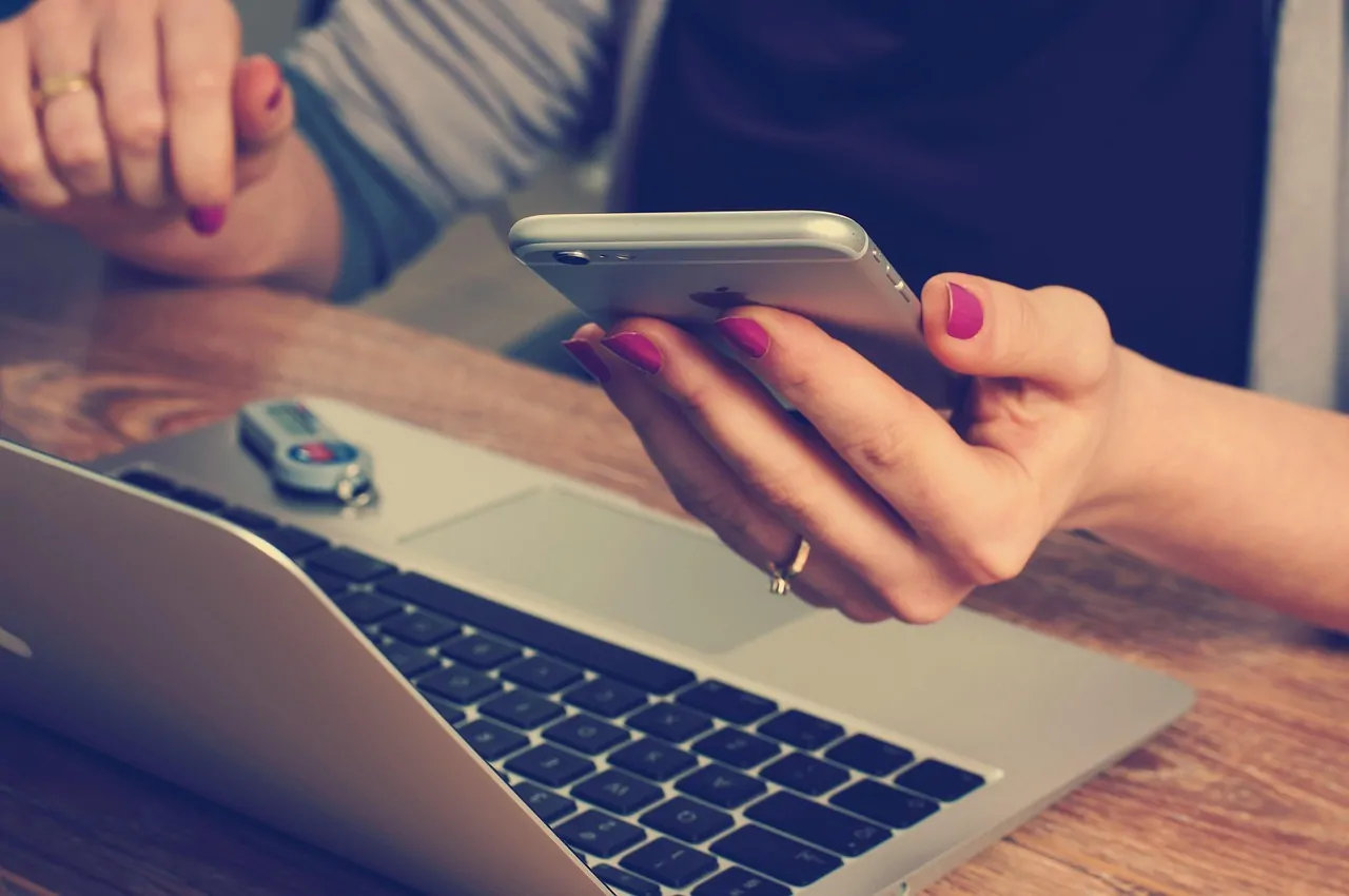 Updated smartphone and laptop displaying account security settings beside a disconnected hardware wallet Updated smartphone and laptop displaying account security settings beside a disconnected hardware wallet