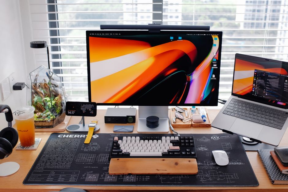 A tidy, well-organized home office setup with dual monitors showing charts and a professional laptop. A tidy, well-organized home office setup with dual monitors showing charts and a professional laptop.