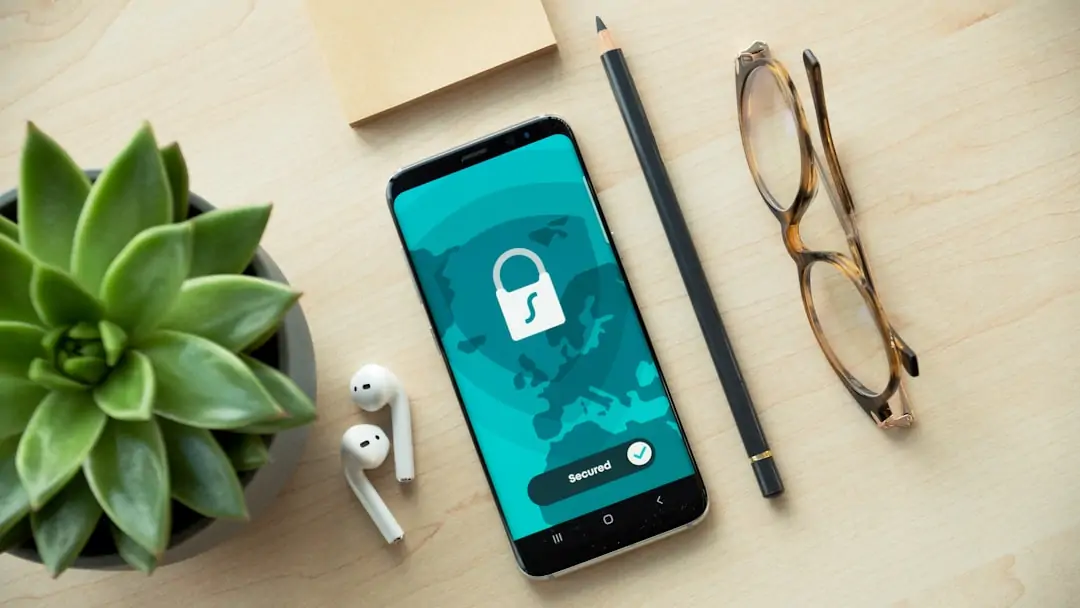 Numbered cybersecurity checklist beside a phone showing privacy controls and authentication settings Numbered cybersecurity checklist beside a phone showing privacy controls and authentication settings