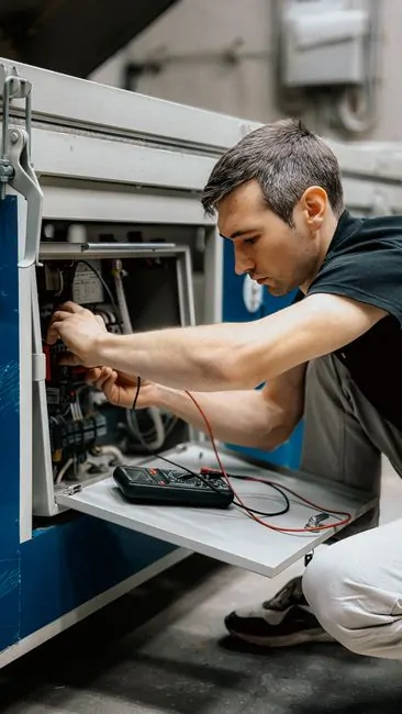 Mining technician inspecting ASIC hardware, cooling pipes, power meters, and maintenance records Mining technician inspecting ASIC hardware, cooling pipes, power meters, and maintenance records