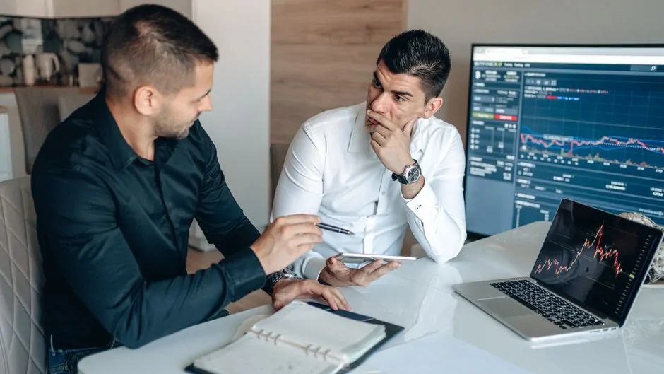 Analysts comparing two cryptocurrency crime reports on screens with methodology and trend charts Analysts comparing two cryptocurrency crime reports on screens with methodology and trend charts